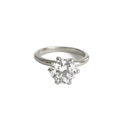 BRILLIANT CUT SOLITAIRE WITH FIVE STONE CURVED BAND