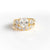 CUSHION CUT ENGEMENT RING WITH SIDE DIAMONDS AND FIVE STONE CURVED BAND IN YELLOW GOLD PLATING.