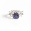 SAPPHIRE CUSHION CUT ENGAGEMENT RING WITH SIDE DIAMONDS AND FIVE STONE CURVED BAND