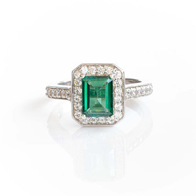 EMERALD CUT & COLOURED HALO RING