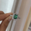 EMERALD CUT & COLOURED HALO RING